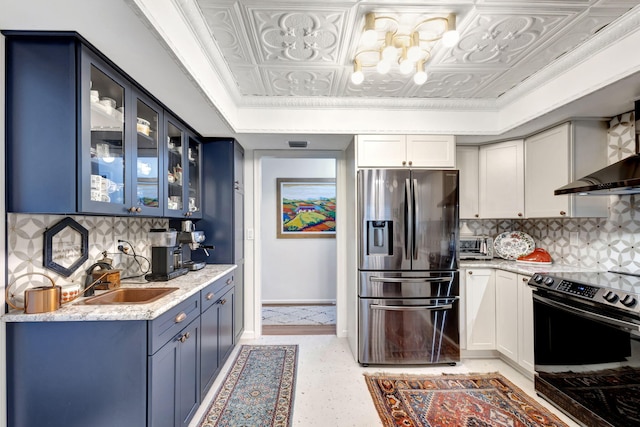 kitchen featuring black electric range, stainless steel fridge, white cabinets, and sink