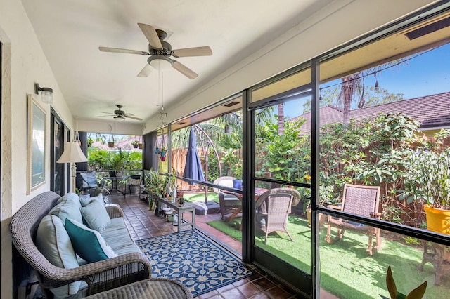 sunroom / solarium featuring ceiling fan