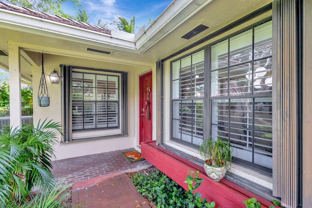 doorway to property featuring cooling unit and covered porch