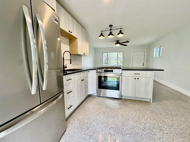 kitchen featuring appliances with stainless steel finishes, sink, kitchen peninsula, ceiling fan, and decorative backsplash