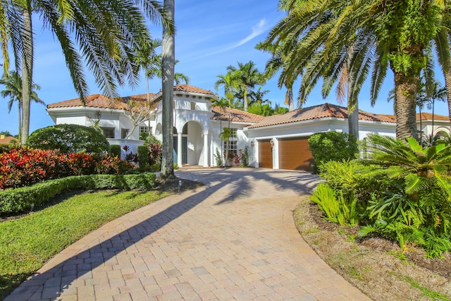 mediterranean / spanish-style home with a garage