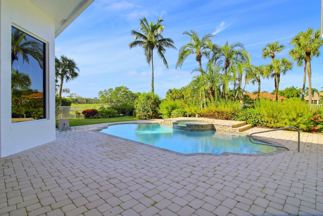 view of swimming pool featuring an in ground hot tub and a patio