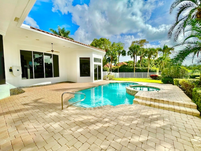 view of swimming pool featuring ceiling fan, an in ground hot tub, and a patio