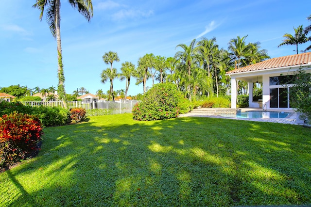 view of yard with a fenced in pool