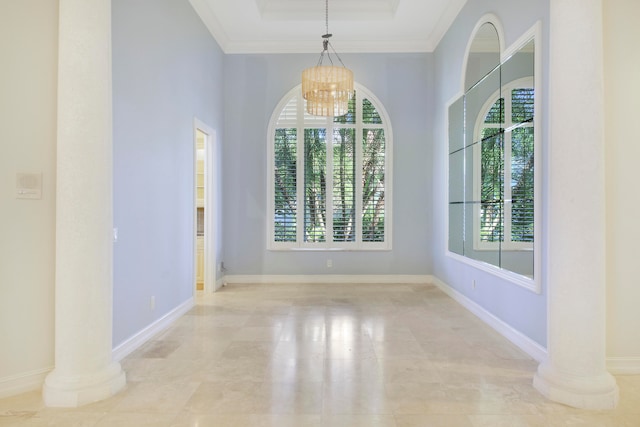 unfurnished dining area with a chandelier, ornate columns, and crown molding