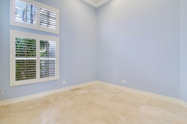 empty room featuring crown molding