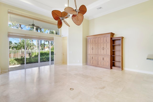 spare room with ceiling fan, a high ceiling, and ornamental molding