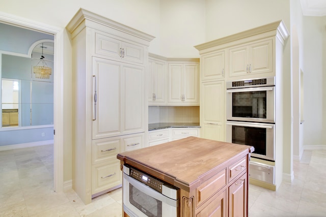 kitchen with light tile patterned floors and double oven