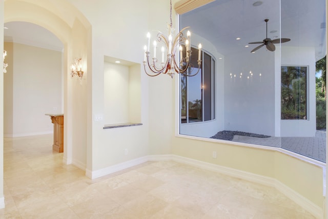 unfurnished room featuring ceiling fan with notable chandelier and ornamental molding