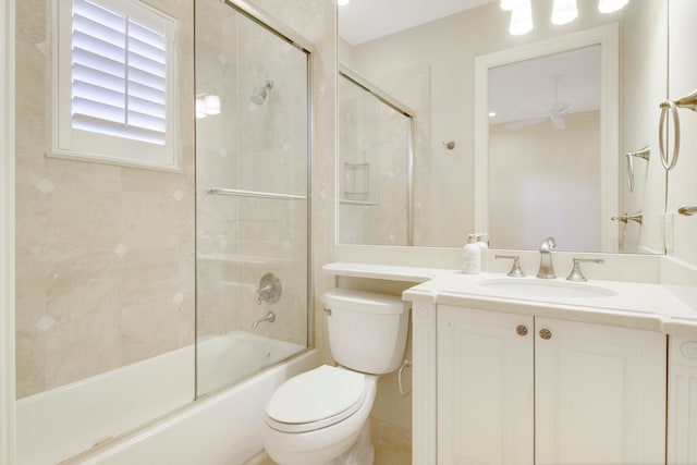 full bathroom featuring ceiling fan, vanity, enclosed tub / shower combo, and toilet