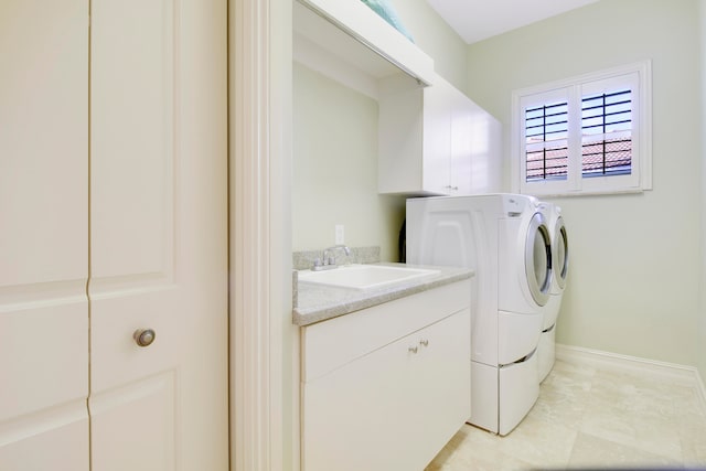 clothes washing area with sink and washer and dryer