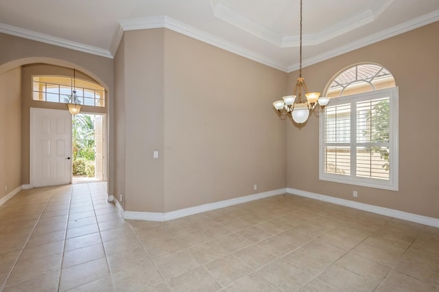 foyer entrance featuring a notable chandelier, ornamental molding, a wealth of natural light, and light tile patterned flooring