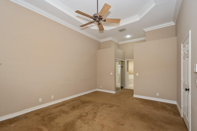 unfurnished bedroom featuring ceiling fan, a tray ceiling, carpet flooring, a towering ceiling, and crown molding