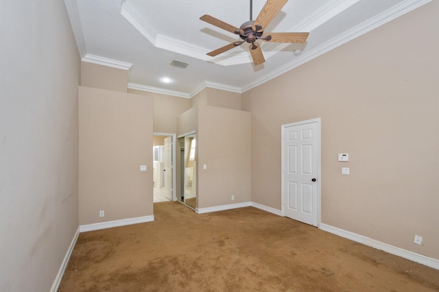 unfurnished room featuring ornamental molding, carpet flooring, a high ceiling, and ceiling fan