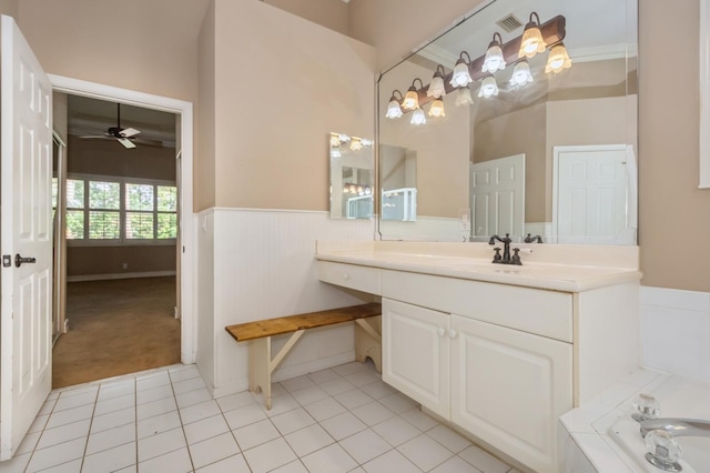 bathroom featuring a bathtub, ceiling fan, ornamental molding, vanity, and tile patterned flooring