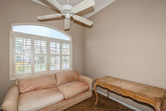 sitting room with ceiling fan, ornamental molding, a wealth of natural light, and carpet floors