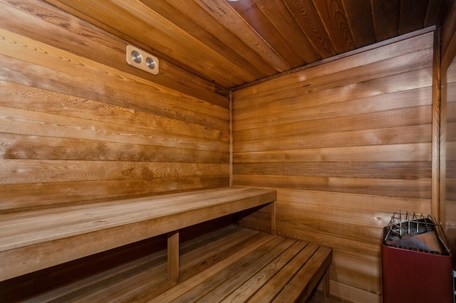 view of sauna with wood walls and wooden ceiling