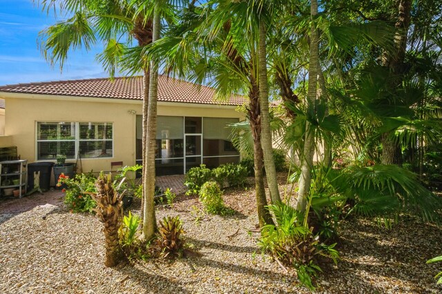 rear view of house featuring a sunroom