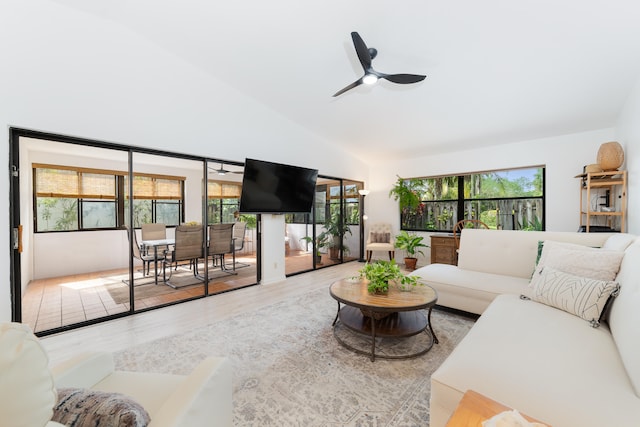 living room with ceiling fan, a healthy amount of sunlight, high vaulted ceiling, and light hardwood / wood-style flooring