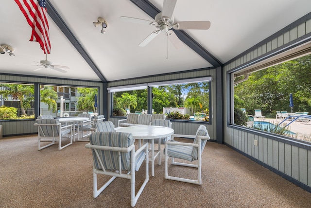 sunroom featuring vaulted ceiling with beams and ceiling fan