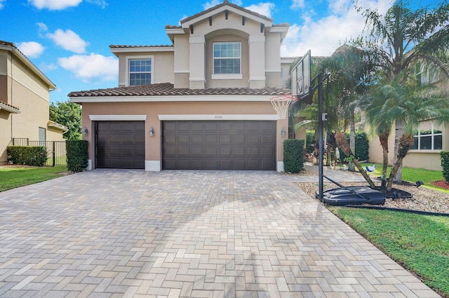 mediterranean / spanish-style home with a garage