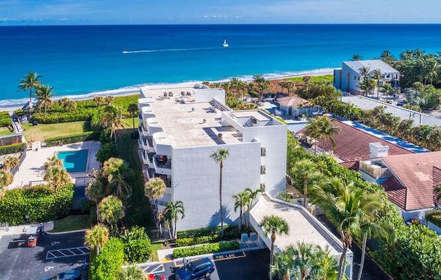 drone / aerial view featuring a water view and a beach view