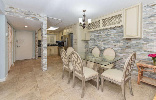 dining area featuring an inviting chandelier