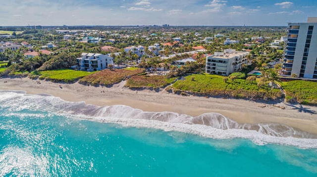 birds eye view of property with a water view and a view of the beach