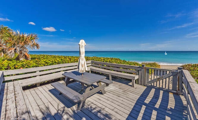 deck featuring a water view and a view of the beach