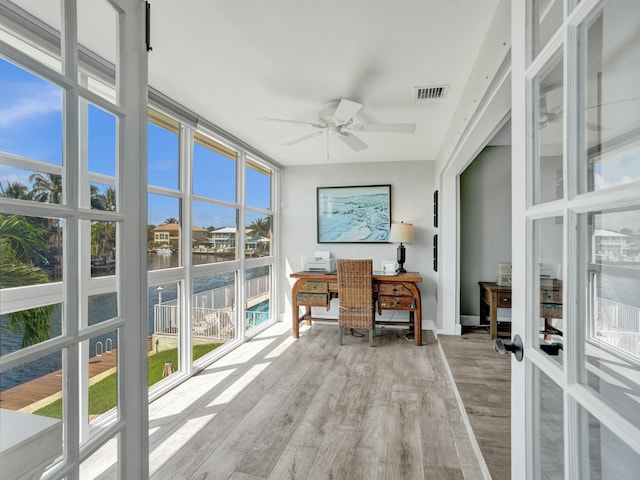 home office with ceiling fan and light hardwood / wood-style flooring