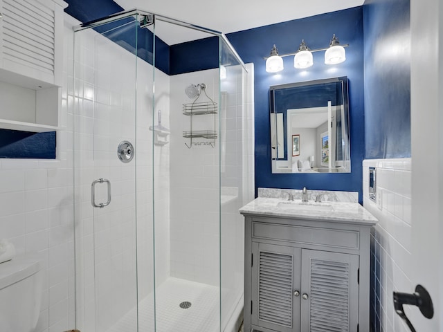 bathroom featuring vanity, toilet, and walk in shower