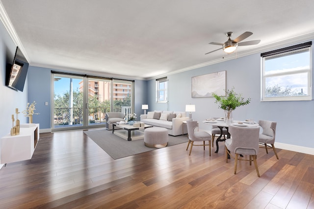 living room featuring a wealth of natural light, crown molding, dark hardwood / wood-style floors, and ceiling fan