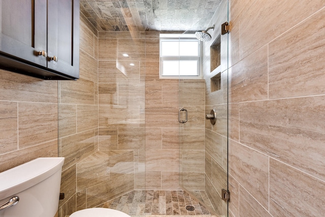 bathroom featuring toilet and an enclosed shower