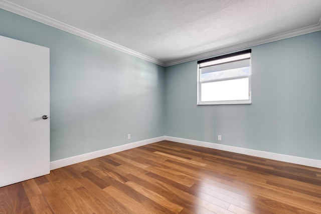 unfurnished room with crown molding, a textured ceiling, and wood-type flooring