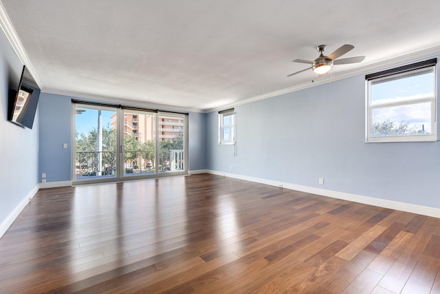 spare room featuring ornamental molding, dark wood-type flooring, and ceiling fan