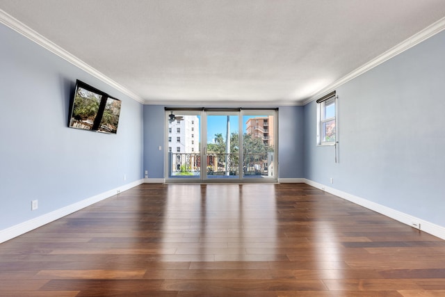 empty room featuring ornamental molding, a textured ceiling, and dark hardwood / wood-style flooring