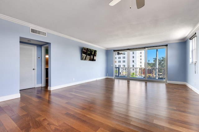 spare room featuring ceiling fan, ornamental molding, and dark hardwood / wood-style floors