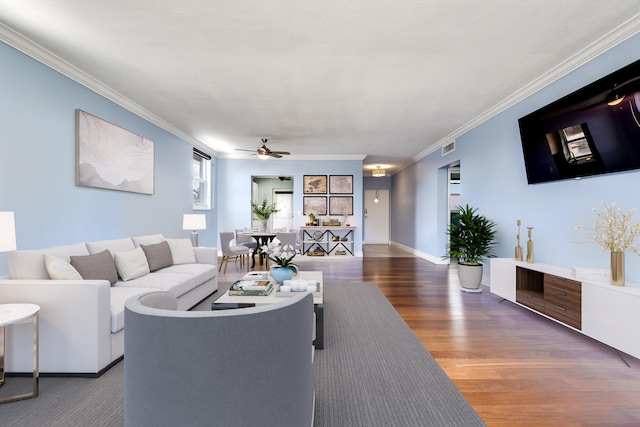 living room featuring ceiling fan, ornamental molding, and dark hardwood / wood-style flooring