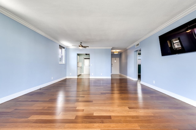 empty room with ornamental molding, hardwood / wood-style floors, and ceiling fan