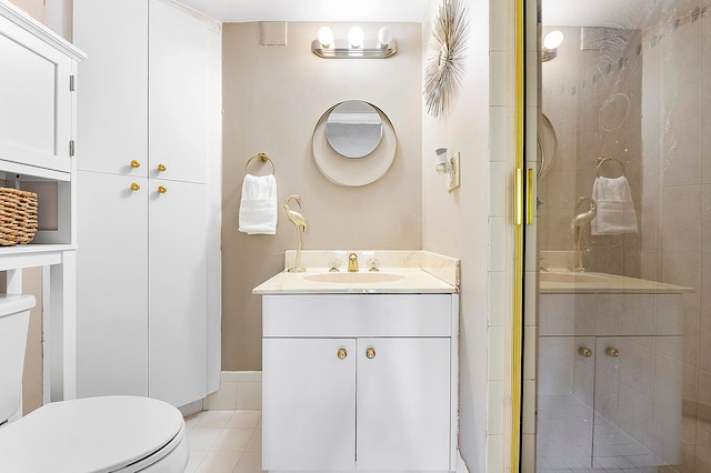 bathroom featuring vanity, a shower with shower door, toilet, and tile patterned flooring