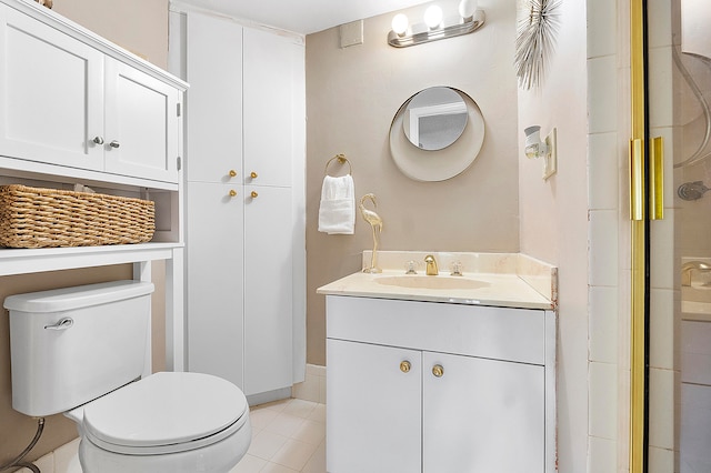 bathroom with walk in shower, vanity, toilet, and tile patterned floors