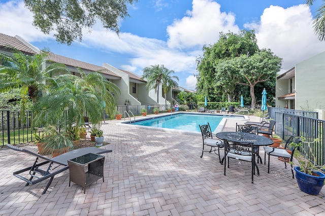 view of swimming pool with a patio