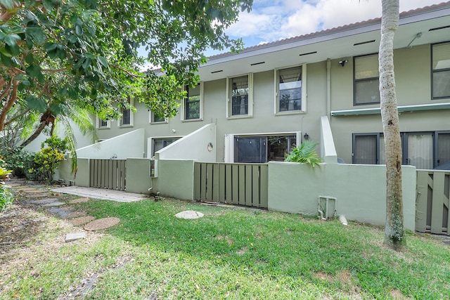 rear view of property with a lawn