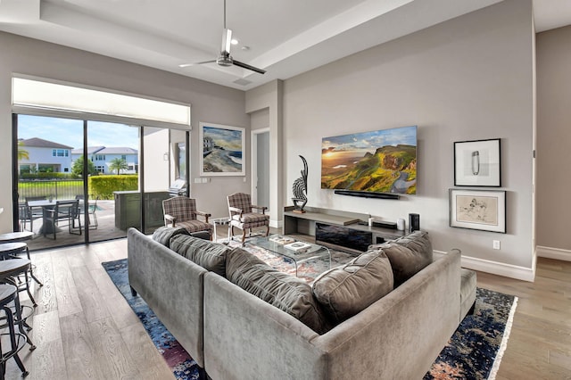 living room with light hardwood / wood-style floors and ceiling fan