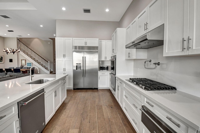 kitchen featuring dark wood-type flooring, appliances with stainless steel finishes, sink, and white cabinets