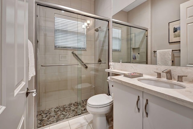 bathroom featuring vanity, toilet, tile patterned floors, and walk in shower