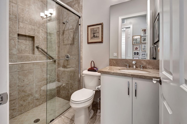 bathroom with vanity, toilet, walk in shower, and tile patterned flooring