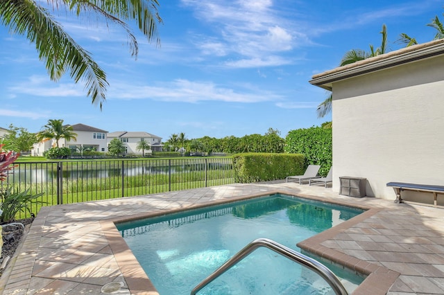 view of swimming pool featuring a patio area and a water view