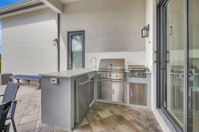 view of patio featuring area for grilling, sink, and a grill