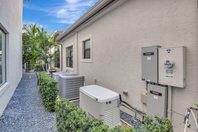 view of side of property with central air condition unit